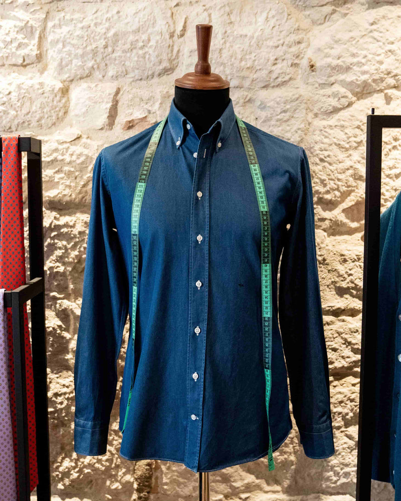 denim-button-down-shirt-with-measuring-tape-in-tailoring-studio