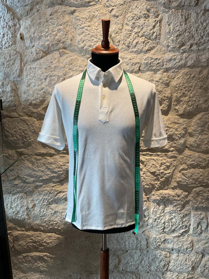 white-polo-shirt-with-measuring-tape-in-tailoring-studio