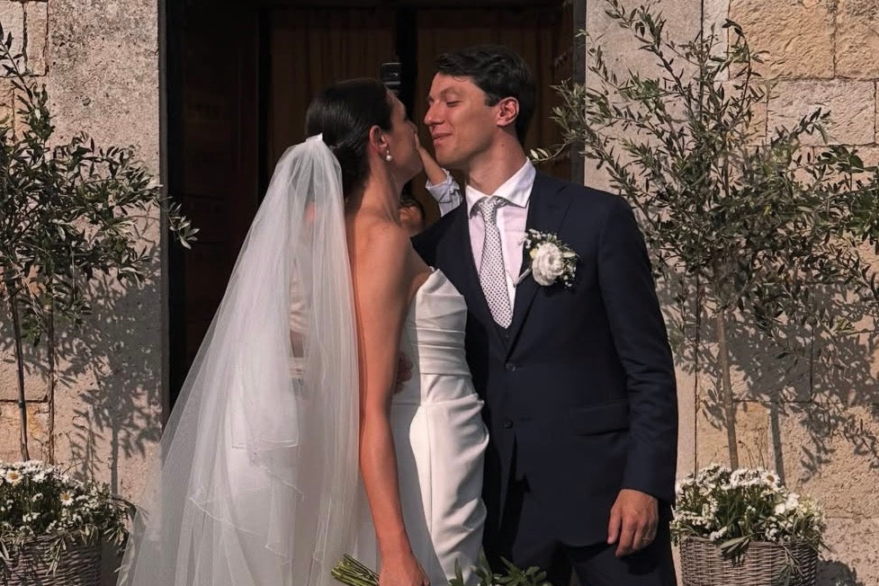 groom-in-wedding-attire-by-caprice-bespoke-standing-close-to-the bride-outdoors