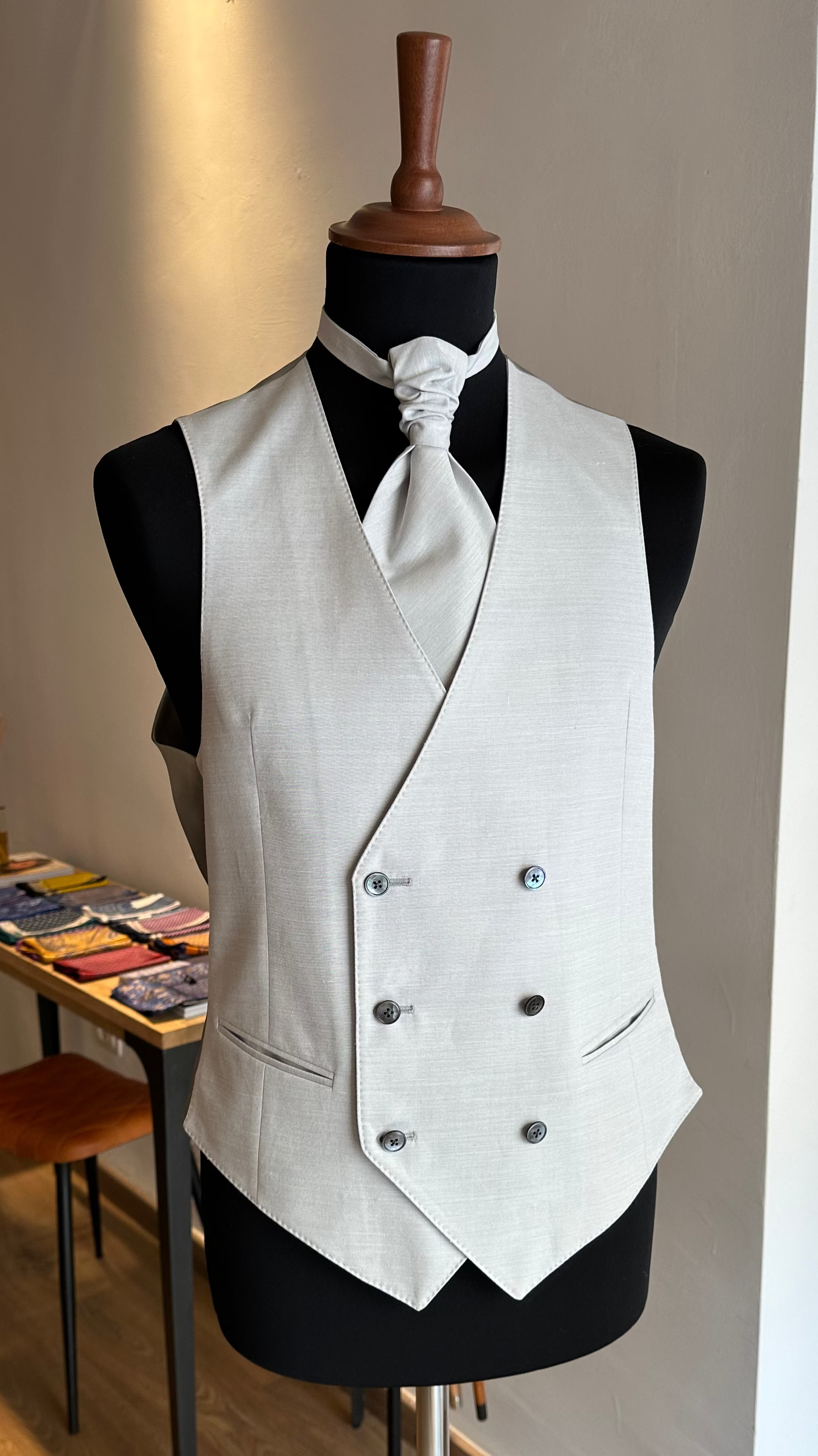 pearl-grey-groom-tailored-waistcoat-paired-with-a-plastron-on-a-mannequin